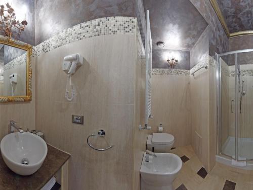 a bathroom with a toilet and a shower and a sink at Antica Dimora Delle Cinque Lune in Rome