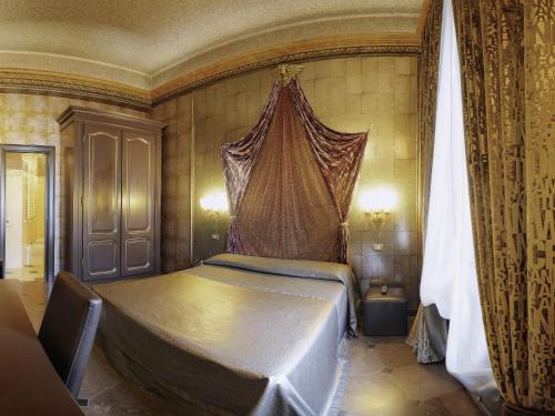 a bedroom with a large bed with a canopy at Antica Dimora Delle Cinque Lune in Rome