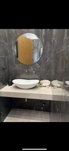 a bathroom with a white sink and a mirror at Blue Sky in Ios Chora