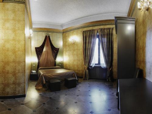 a hotel room with a bed and a window at Antica Dimora Delle Cinque Lune in Rome