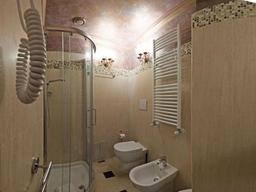 a bathroom with a shower and a toilet and a sink at Antica Dimora Delle Cinque Lune in Rome