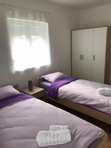 a bedroom with two beds with towels on them at Apartmani & SPA Matin Breg in Jošanička Banja