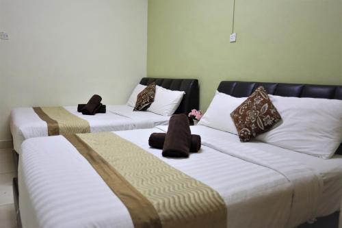Ein Bett oder Betten in einem Zimmer der Unterkunft Camlodge Budget Hotel