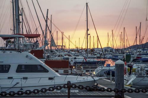 a group of boats docked in a harbor at sunset at Villa Abeto in Yaiza