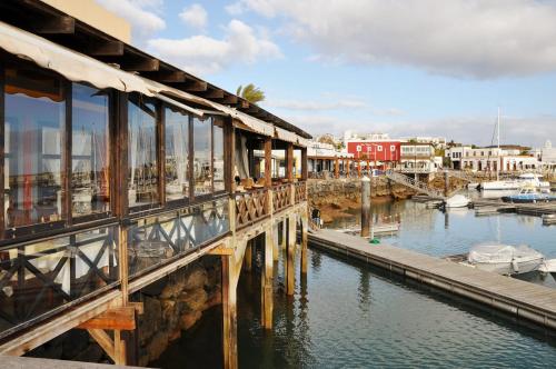 a bridge over a body of water with boats at Villa Abeto in Yaiza