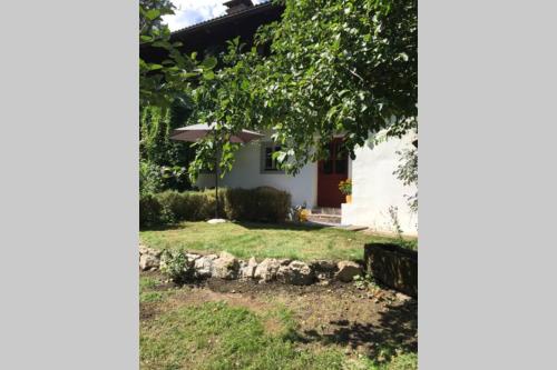 a house with a tree and a yard at Ferienwohnung Schönwörth in Niederbreitenbach