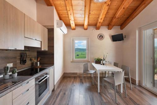 a kitchen with a table and chairs in a room at Sporting Hotel San Felice in Illasi
