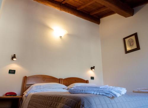 a bedroom with a bed and lights on the wall at Albergo Ristorante Terme in Acquasanta Terme