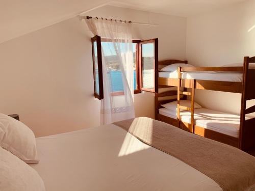 a bedroom with two bunk beds and a window at Apartments Simuni 66 in Šimuni