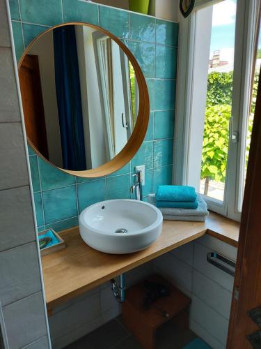 a bathroom with a sink and a mirror at Villa Veda in Zehdenick