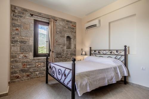 Ένα ή περισσότερα κρεβάτια σε δωμάτιο στο Xenios Kotronas