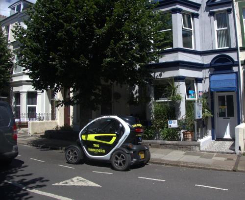 a small car parked on the side of a street at Mariners Guest House in Plymouth
