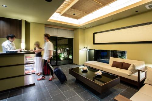 a group of people standing in a living room at Hauza Kyoto Gojo Karasuma in Kyoto