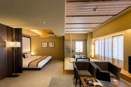 a hotel room with a bed and a couch at Hauza Kyoto Gojo Karasuma in Kyoto