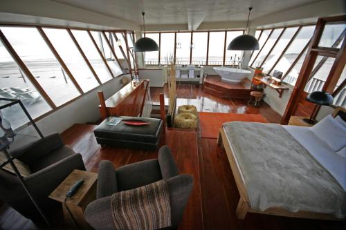 a bedroom with a bed and a bath room at Pelican Point Lodge in Walvis Bay