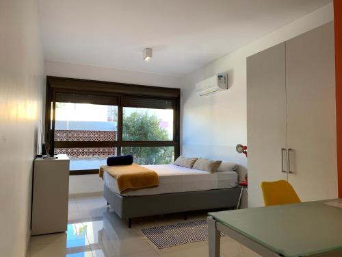 a bedroom with a bed and a couch and a window at Apartamento Perfeito Casemiro, 199 - RETIRADA DAS CHAVES MEDIANTE AGENDAMENTO COM UMA HORA DE ANTECEDÊNCIA COM ANDREIA OU LUIS in Porto Alegre