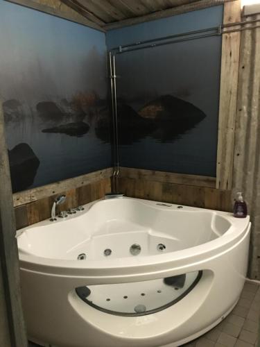 a bath tub in a bathroom with a shower at Villa Kultaa in Kotka