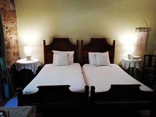a hotel room with two beds and two lamps at Quinta da Mata - Turismo de Habitação in Chaves