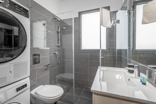 a bathroom with a toilet and a sink at Superb 1,5 BDR W balcony close to the beach in Tel Aviv