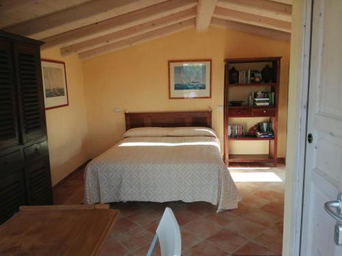 a bedroom with a bed in a room at Appartamento a Feraxi in Muravera