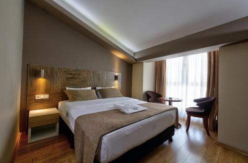Ένα ή περισσότερα κρεβάτια σε δωμάτιο στο Arus Hotel