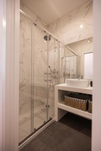 a bathroom with a shower and a sink at MyTrip Porto in Matosinhos