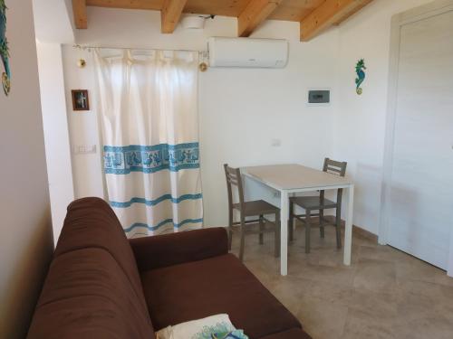 a living room with a couch and a table at Villa "Maritima" in SantʼAndrea