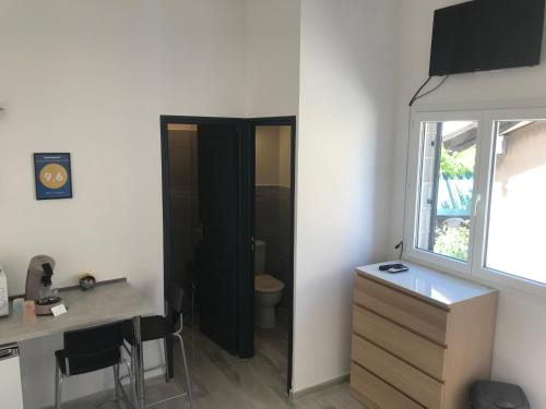 a bathroom with a sink and a desk and a mirror at Beach House in Fos-sur-Mer