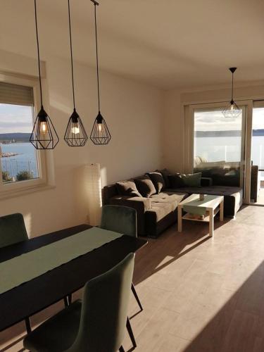 a living room with a couch and a table at SMARAGD on the beach in Povljana