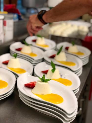 a group of white plates of food on a counter at Hotel Landhaus Zillertal in Fügen