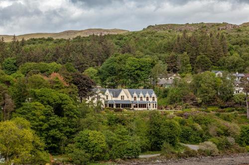 an aerial view of a large house in the forest at Cuillin Hills Hotel in Portree