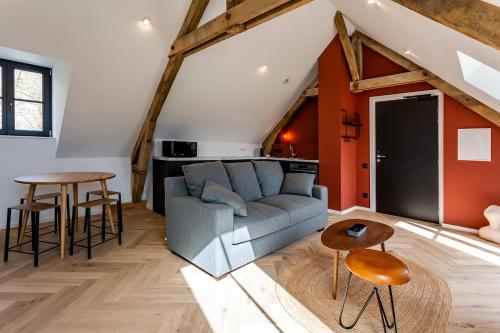 a living room with a couch and a table at HARAS DE BARRY in Sainghin-en-Mélantois