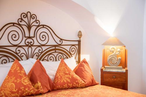 a bedroom with a bed with orange pillows at Silva Apartments in Alberobello