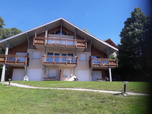 a building with balconies on the side of it at Les Adrets in Gérardmer