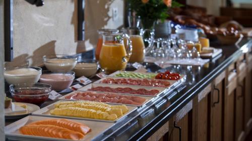 a buffet with many different types of food on display at Hotel & Spa Cacciatori in Cademario