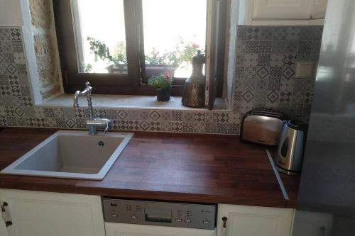 a kitchen counter with a sink and a window at Traditional stone house in Sitia