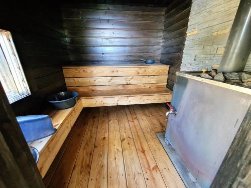 an inside view of a sauna in a wooden cabin at Topin Tuvat in Oravisalo