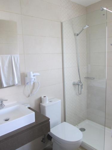 a bathroom with a toilet and a sink and a shower at Baleal à Vista in Baleal