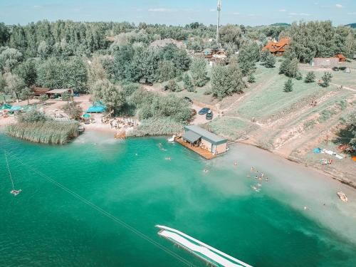 an aerial view of a beach with people in the water at Costa del Kryspi Całoroczne Domy na Wodzie in Cholerzyn