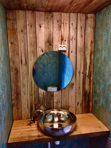 a bathroom with a bowl sink on a wooden shelf at Villa Kultaa in Kotka