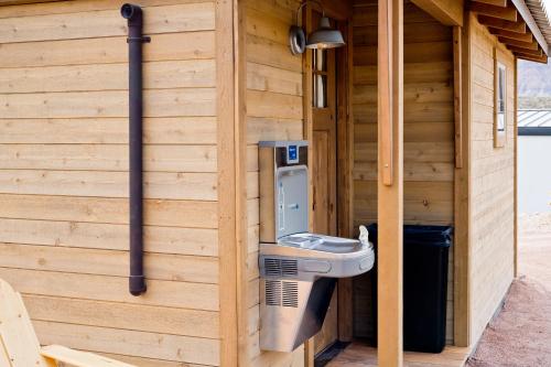 a toilet in the side of a wooden building at Zion Wildflower Resort in Virgin