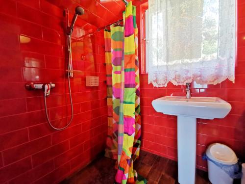 a red bathroom with a sink and a shower at Котеджі на приватному пляжу - Совіньйон 2025 in Odesa