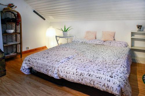 a bedroom with a bed with a white comforter at The Cozy Little House in Motala