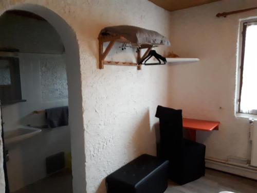 a room with a chair and a table and a window at à La Paloma in Verteuil-sur-Charente