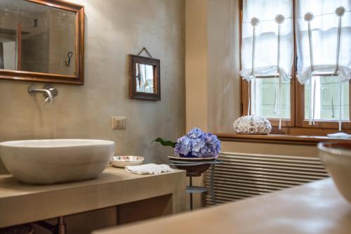 a bathroom with a sink and a bowl on a counter at Villa Francescon in Belluno