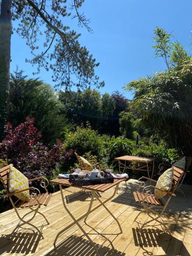 a patio with two chairs and a table and a table at The Devonian in Ilfracombe
