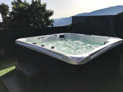 a bath tub sitting on the side of a yard at Casitas Las Uvas y las Viñas in Los Realejos