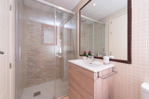 y baño con lavabo y ducha acristalada. en AMATISTA BEACH - Apartamento primera línea, en Calpe