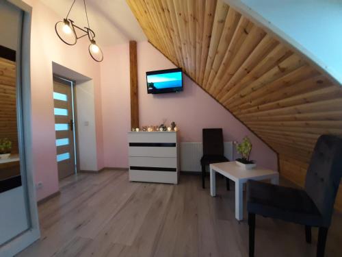 a living room with a wooden ceiling at Apartament Górski Raj in Świeradów-Zdrój