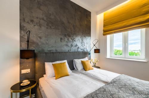 a bedroom with a bed and a window at Panorama Przemyśl in Przemyśl